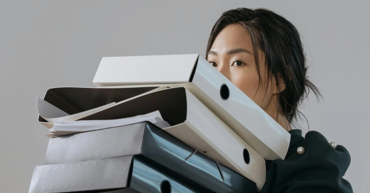 Woman holding documents in an office, symbolizing responsibility in every detail of business.