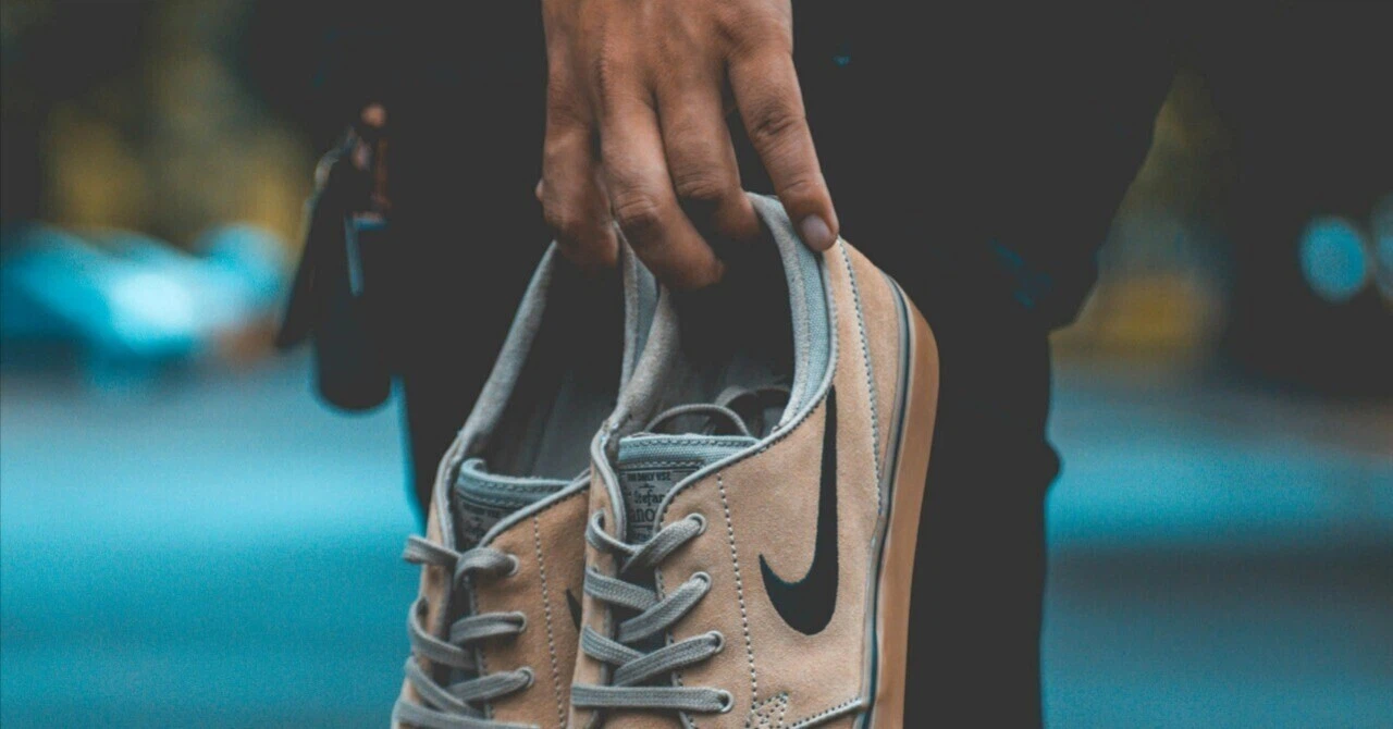 A person holding Nike sneakers, symbolizing the redefinition of TPO in the remote work era.