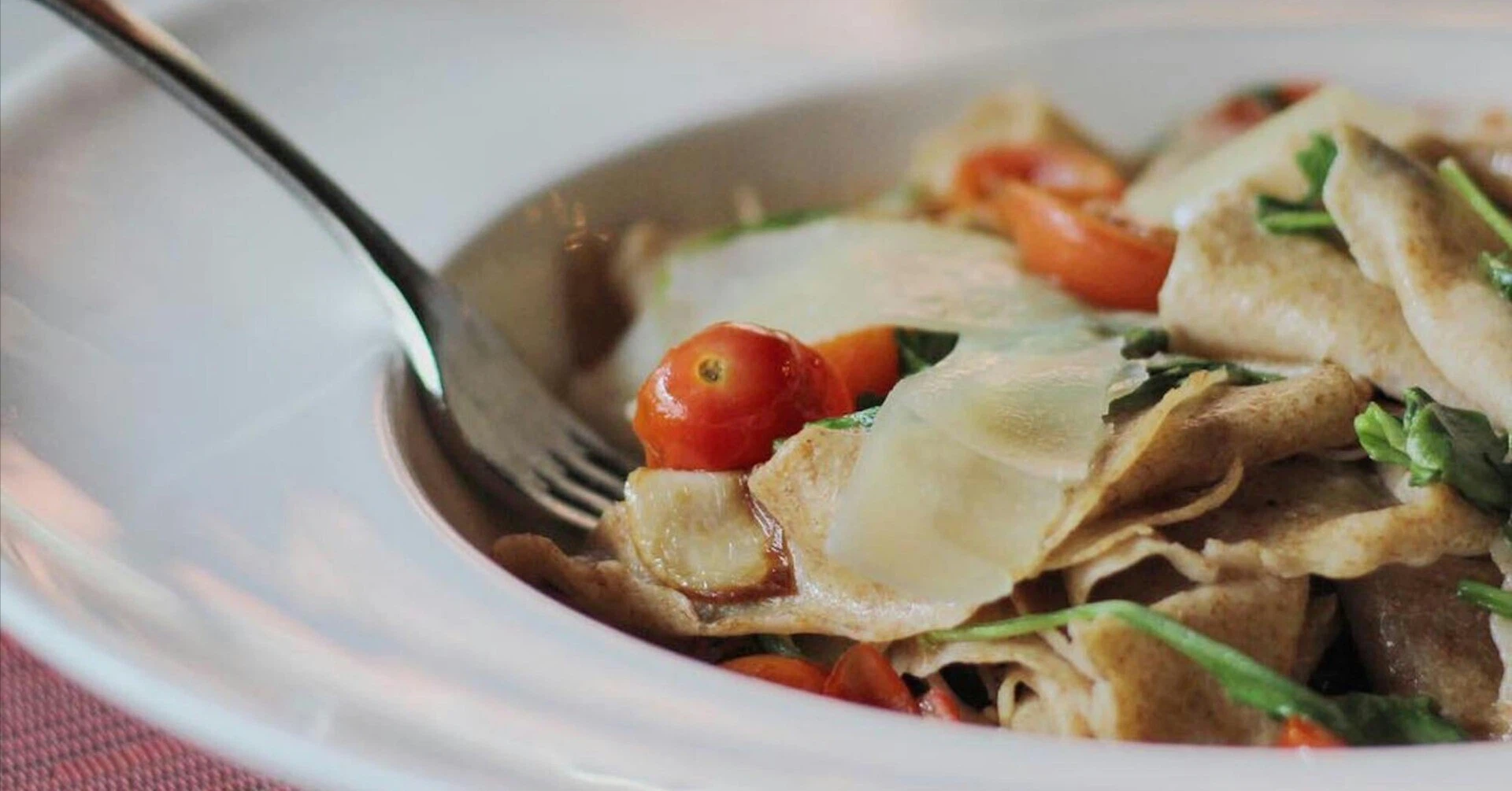 Close-up of an authentic pasta dish with tomato and cheese served at a high-end Italian restaurant