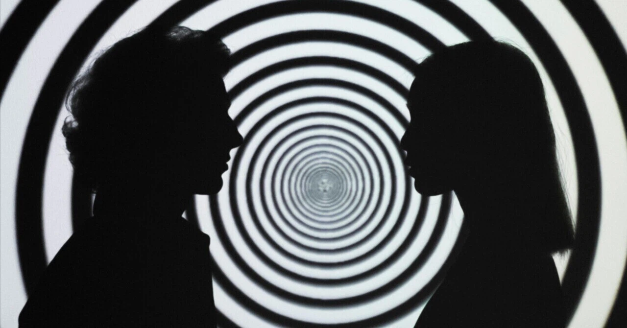 Silhouettes of two people facing each other in front of a black and white spiral pattern (tunnel effect).