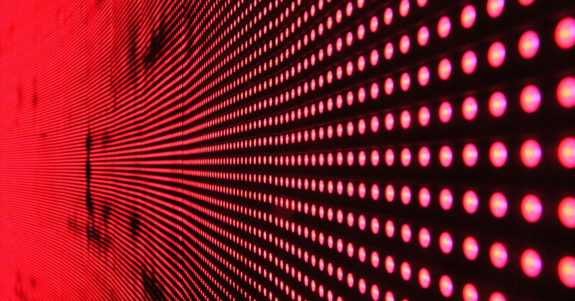 A matrix-style image symbolizing digital data and technology, with red LED lights arranged and glowing in a regular pattern